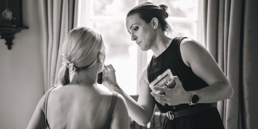 Multi award winning Essex bridal makeup artist Lynsey applying makeup to a bride on her wedding day.